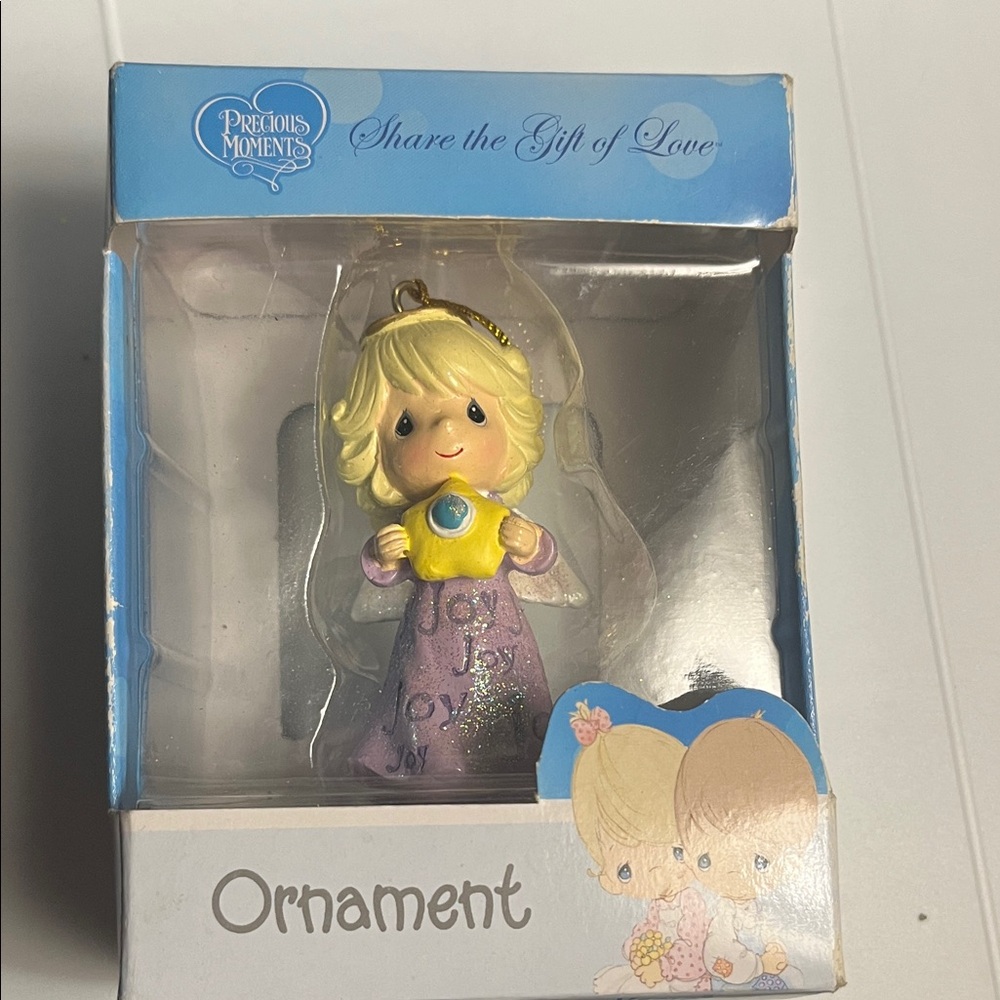 Precious Moments Blonde Angel with Yellow  and blue center Star Ornament